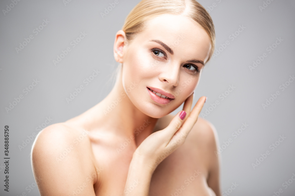 Naklejka premium Beauty portrait of young woman with healthy skin and soft natural make up. Spa and care. Long beautiful blonde hair
