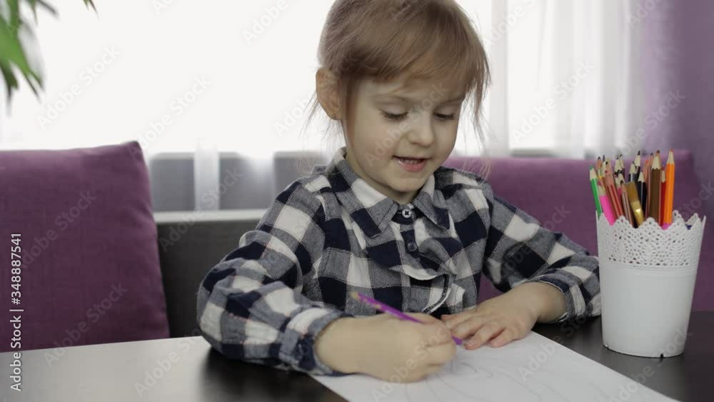 Cute child girl studying drawing picture with pencil at home. Distance education Cute child girl studying drawing picture with pencil at home. Distance education