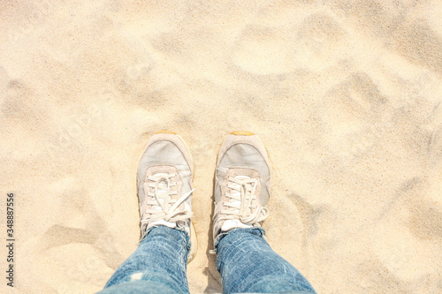 Female legs in jeans and sneakers