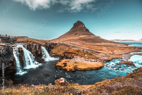 The famous Icelandic mountain Kirkjufell and the small waterfalls, one August morning