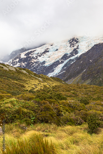 Valley in the Southern Alps among snow-capped mountains and hills. South Island, New Zealand