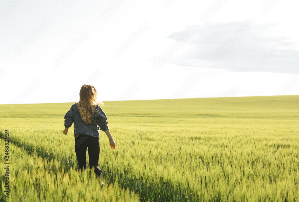 Young blonde girl running through the green wheat field. Concept of travel, inspiration, freedom, lifestyle.
Young blonde girl running through the green wheat field. Concept of travel, inspiration, freedom, lifestyle.