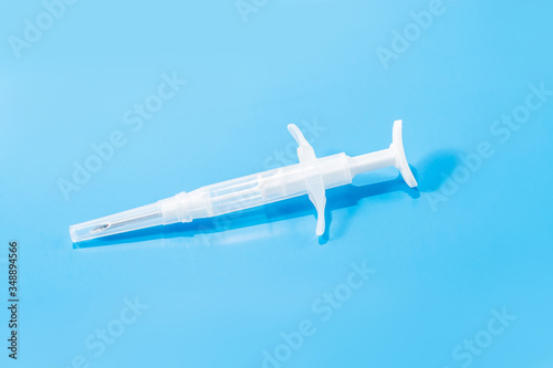 syringe with a microchip on a blue background, chipping,nobody, close up