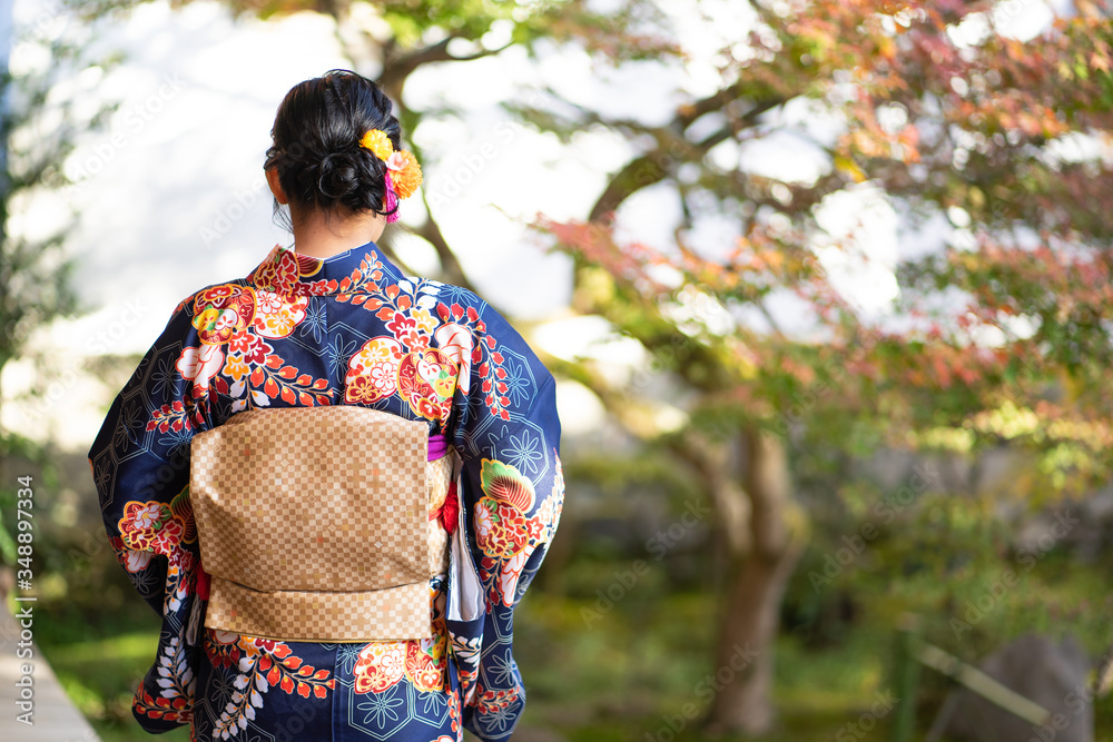 Geishas girl wearing Japanese kimono among red wooden Tori Gate at Fushimi Inari Shrine in Kyoto, Kimono is a Japanese traditional garment. The word Geishas girl wearing Japanese kimono among red wooden Tori Gate at Fushimi Inari Shrine in Kyoto, Kimono is a Japanese traditional garment. The word