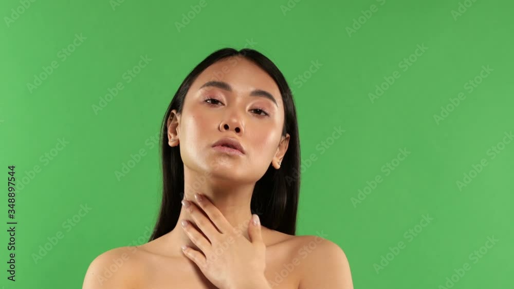 Portrait of beautiful young asian woman clean fresh nude skin concept. Asian beauty girls face skin care and wellness, face care, perfect skin, natural makeup. Isolated on green background Portrait of beautiful young asian woman clean fresh nude skin concept. Asian beauty girls face skin care and wellness, face care, perfect skin, natural makeup. Isolated on green background