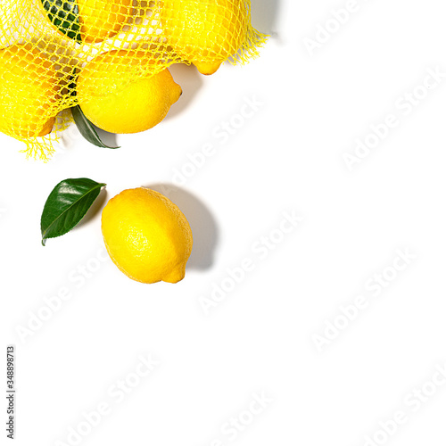 Creative layout made of yellow lemon with leaves on white color background.