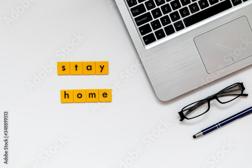 Laptop with message of stay home during global pandemic problem, coronavirus. Lockdown, working remotely from home