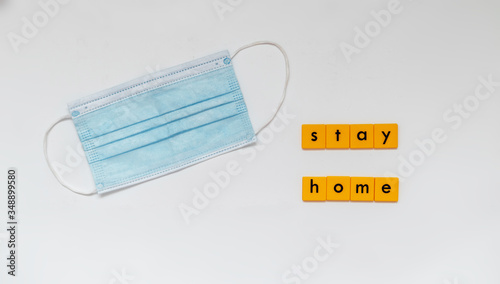 Medical face protection mask with stay home message. Coronavirus pandemic, covid-19 virus