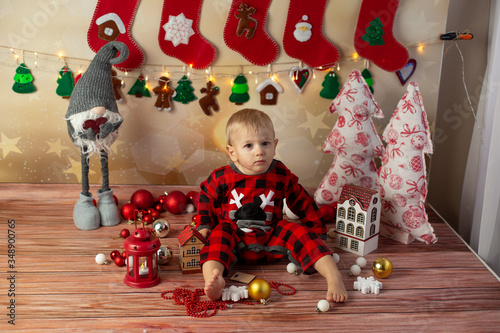 a little boy in the new year's photo zone. children's new year photo session. a child on Christmas morning