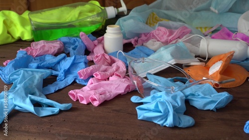 Wallpaper Mural Used personal protective equipment (PPE) waste (gloves, single-use masks, safety glasses) from healthcare workers. Plastic pollution after the COVID-19 pandemic Torontodigital.ca