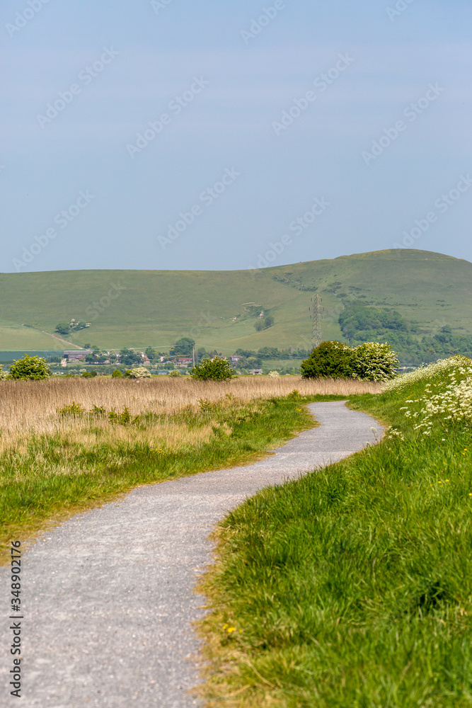 A pathway through the Sussex countryside, on a sunny spring day