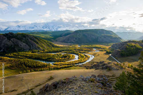 Autumn landscape with mountains, winding river, forest and highway. Altai.