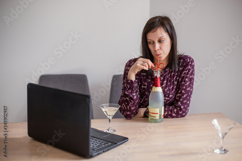 online alcoholism. Toast with a laptop over the internet close-up. Self-isolation distance solitude quarantine. Alcohol glass wine drink videoconference telecommunications technology cheers photo