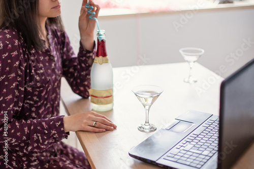 online alcoholism. Toast with a laptop over the internet close-up. Self-isolation distance solitude quarantine. Alcohol glass wine drink videoconference telecommunications technology cheers photo