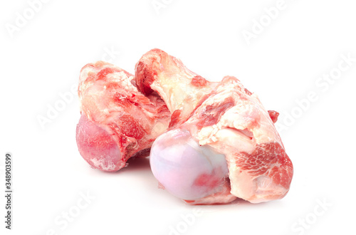 Close up frozen fresh pork bones with red meat stuck To be used for making pork bone broth on a white background