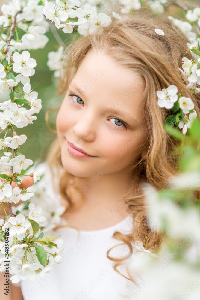 Fototapeta premium Close-up portrait of a beautiful girl with white flowers