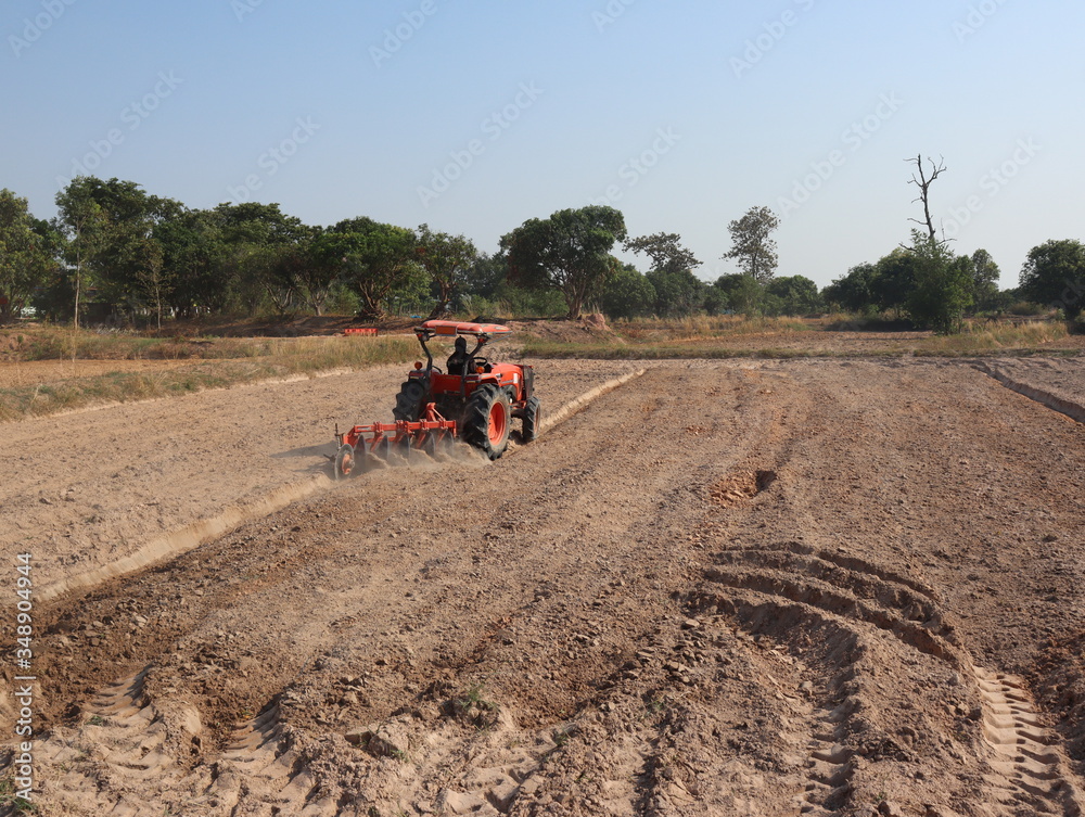 Farmers use tractors to plow the land to cultivate rice. Farmers use tractors to plow the land to cultivate rice.