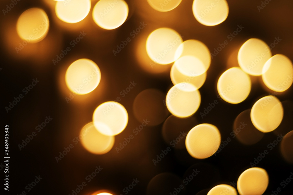Obraz premium Yellow Christmas Background of round light bulbs With bokeh