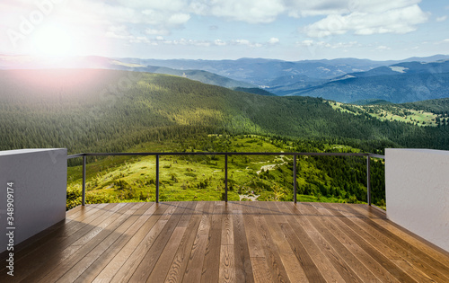 Luxury terrace in the mounting house. Balcony view of mountains. Background with beautiful landscape. Sunny Day. Terrace with a beautiful view.