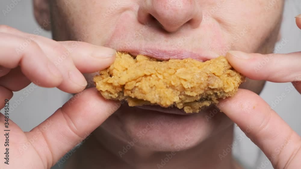 Woman eating fried chicken fast food closeup. Woman eating fried chicken fast food closeup.
