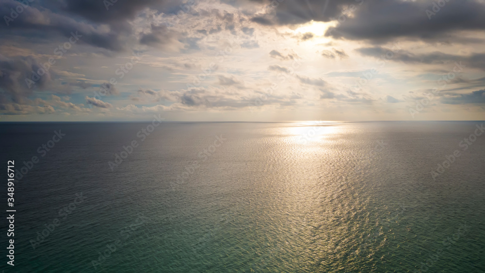 Aerial Drone view sunset over the sea with cloud and sun light with copy space.
