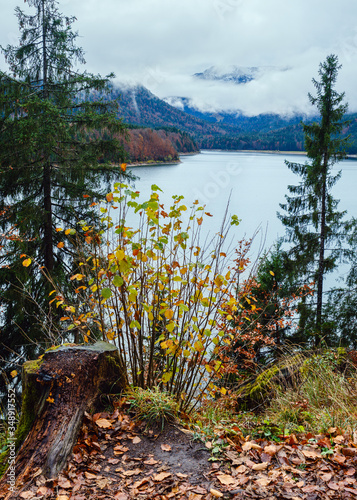 Alpine  Sylvenstein Stausee lake on Isar river, Bavaria, Germany. Autumn overcast, foggy and drizzle day. Picturesque traveling, seasonal, weather, and nature beauty concept scene. photo