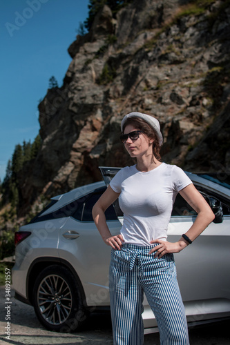 Beautiful stylish young girl travels by car, summer travel, freedom, transport for rent, new impressions and adventure, freedom and youth