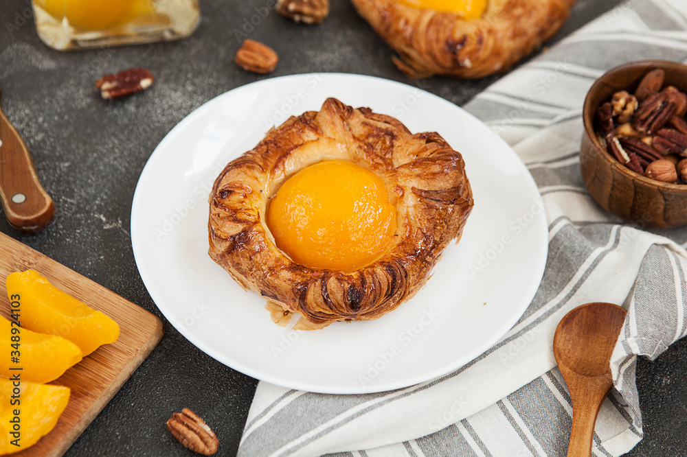 tartlet with apricot, sweet pastries on a black background, pastry shop. tartlet with apricot, sweet pastries on a black background, pastry shop.