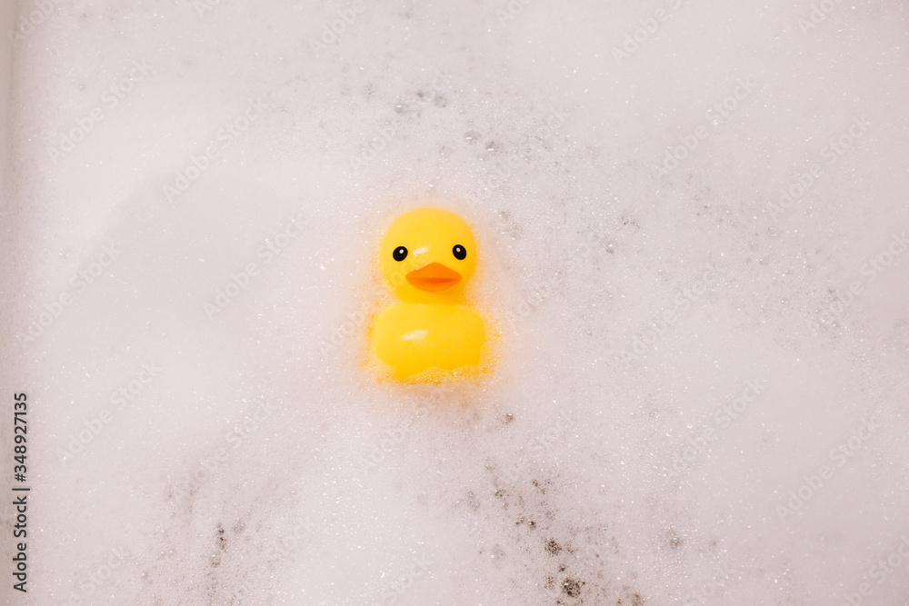 Yellow rubber duck in the bath with bubble foam Yellow rubber duck in the bath with bubble foam