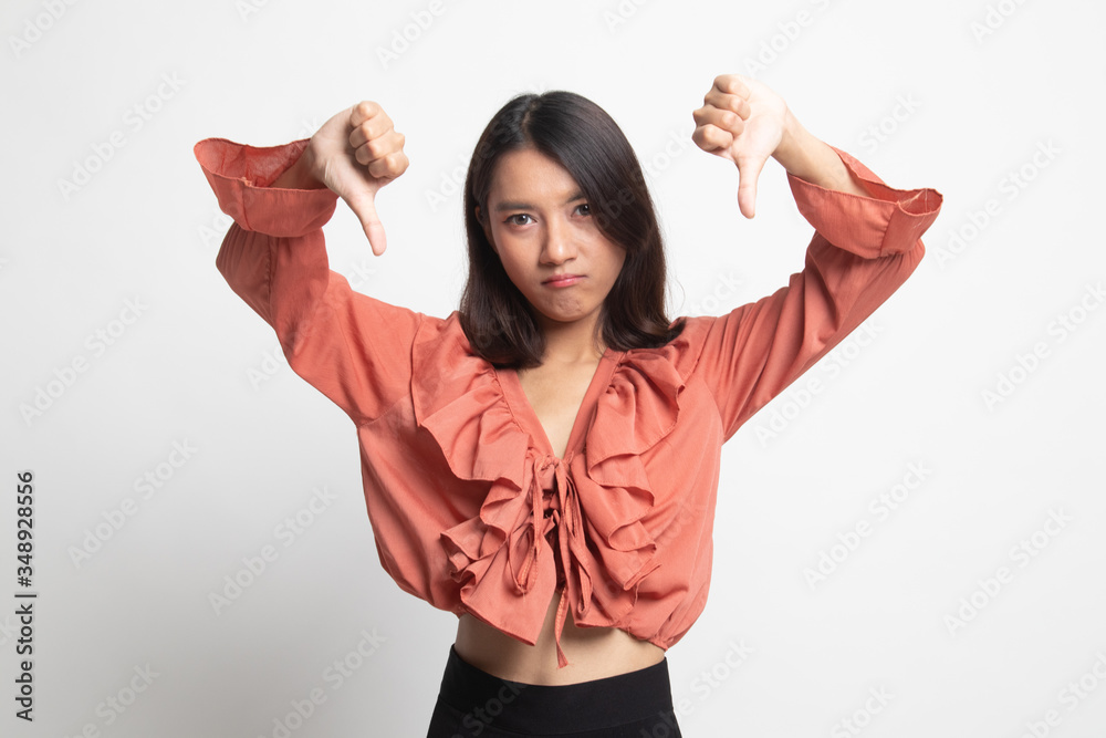 Unhappy Asian girl show thumbs down with both hands . Unhappy Asian girl show thumbs down with both hands .