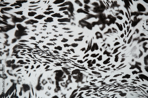 Black and white abstract camouflage. The concealment pattern on a fabric. Concept of winter masking.