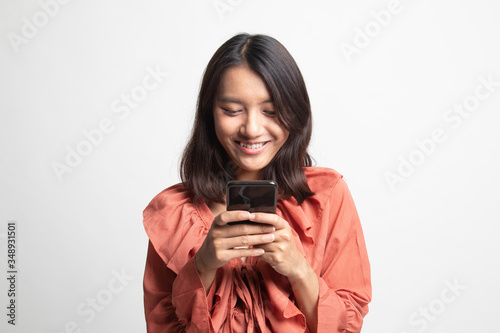 Young Asian woman with mobile phone .