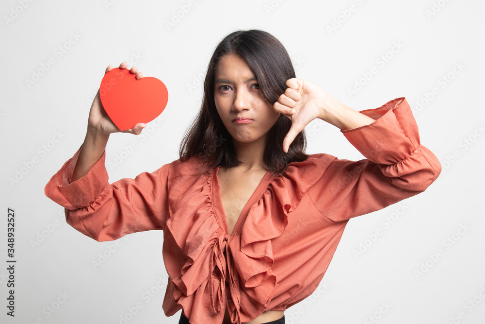 Asian woman thumbs down with red heart . Asian woman thumbs down with red heart .