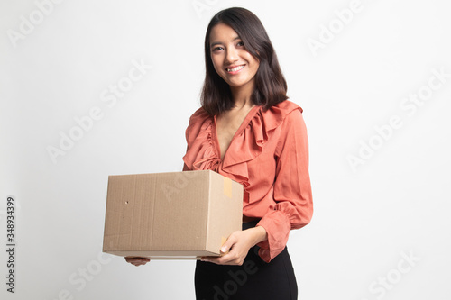 Delivery, relocation and unpacking.  young asian woman holding cardboard box . © halfbottle