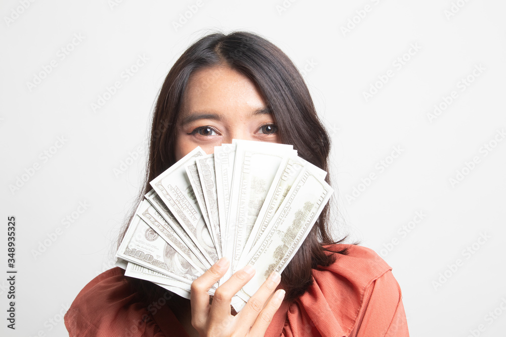 Portrait of young asian woman showing bunch of money banknotes . Portrait of young asian woman showing bunch of money banknotes .