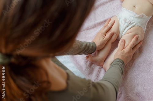 mother does back and a foot massage to a newborn baby. mother's care. healthy lifestyle.