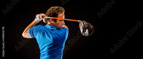 Portrait of a golf player perfecting the swing isolated on dark background, banner image © trattieritratti