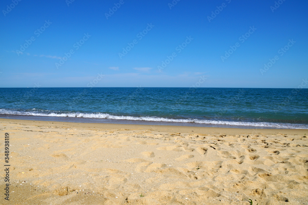 empty beach in the summer - sea, sand, white waves
