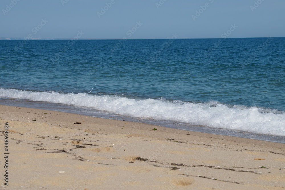 empty beach in the summer - sea, sand, white waves
empty beach in the summer - sea, sand, white waves