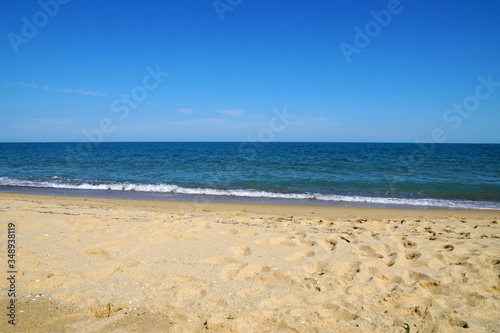 Fototapeta Naklejka Na Ścianę i Meble -  empty beach in the summer - sea, sand, white waves
