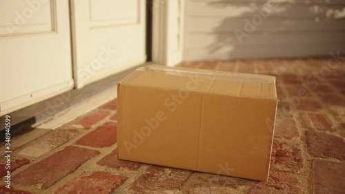 Contactless delivery of a parcel, courier delivering package to the doorstep