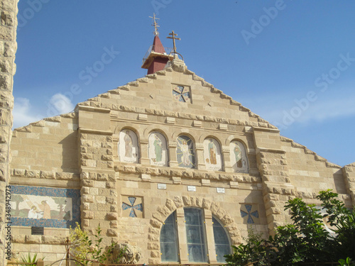 View of the main facade of St. John the Baptist Roman Catholic Church in Madaba, Jordan. Saint John the Baptist is the main Catholic Church in the town and it is made in Roman style photo