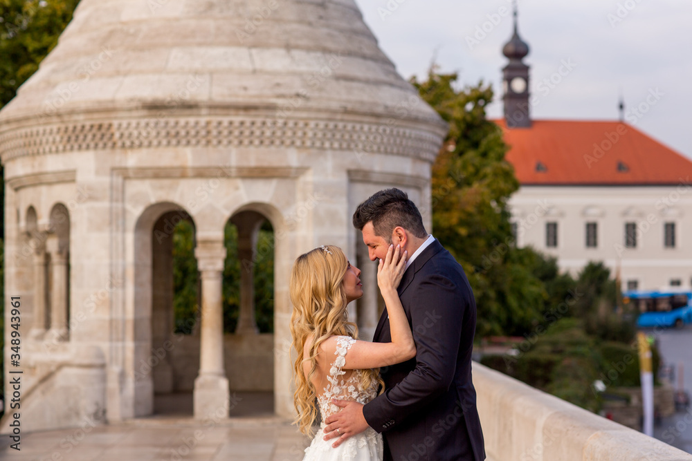 Fototapeta premium beautiful wedding couple posing in old medieval city