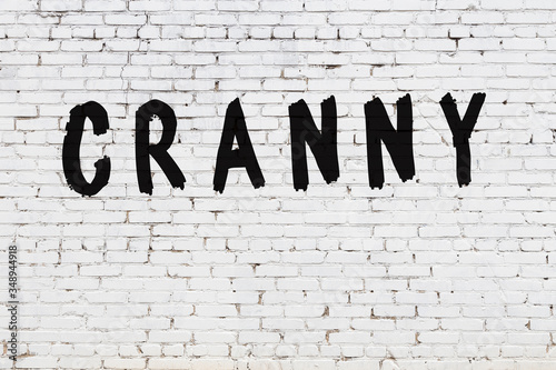 Word cranny painted on white brick wall