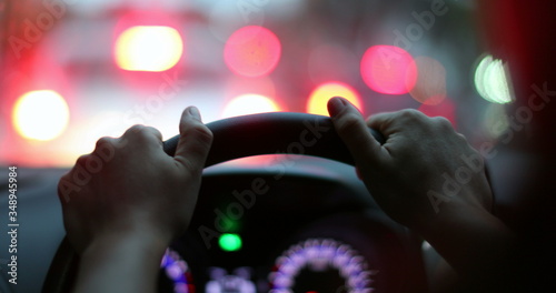 Close-up hands holding steering wheel stop in traffic waiting. photo