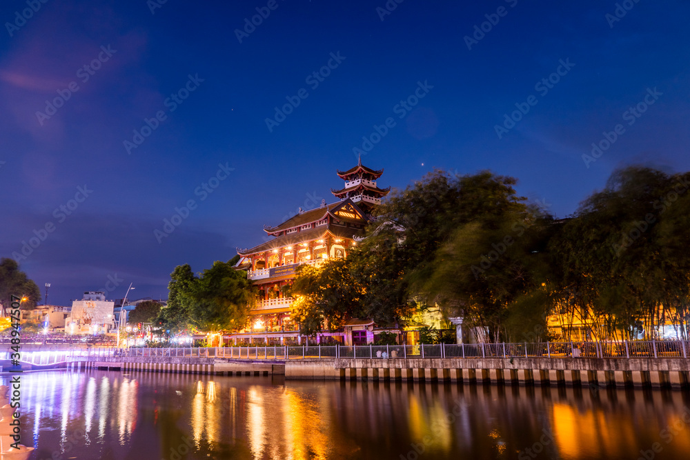 Night scene of Phap Hoa pagoda along Nhieu Loc canal (Saigon river) at night in Ho Chi Minh City, Vietnam