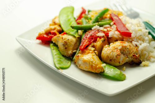 Chicken breast pieces in a Thai red curry sauce made with coconut cream, red chillies, lemongrass, lime leaf, with fragrant rice, red peppers, mange tout, and green beans