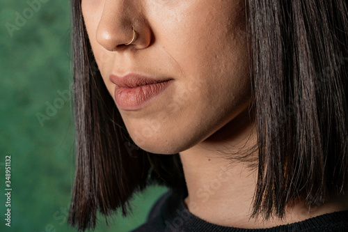 Close up of young woman with nose piercings