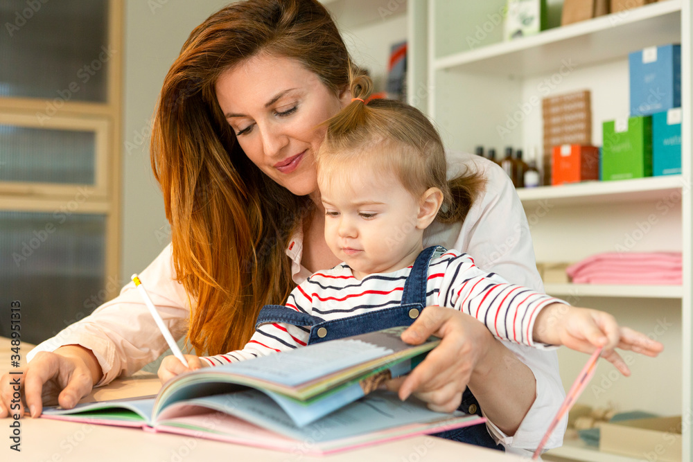 Mother mother reading book to her toddler Mother mother reading book to her toddler