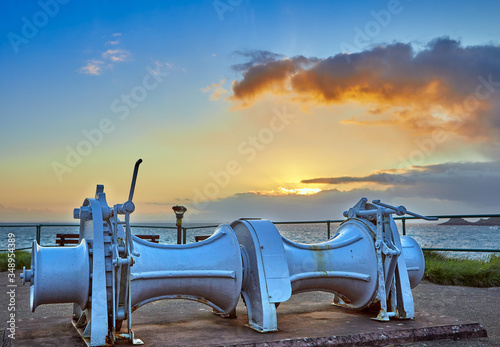 Image of La Mouve Winch at Bouley Bay at sunrise with the sea and headland in the background. Jersey Channel Islands photo